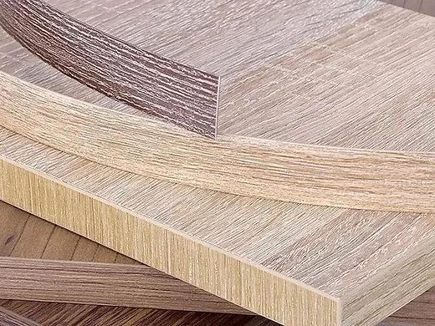 Close-up of furniture edge finished with solid wood veneer banding